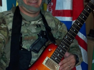 Captian V with his Rambler Travel Guitar in Afghanistan
