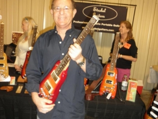 Jerry S. checking out a Rambler Travel Guitar at the Orlando Guitar Expo