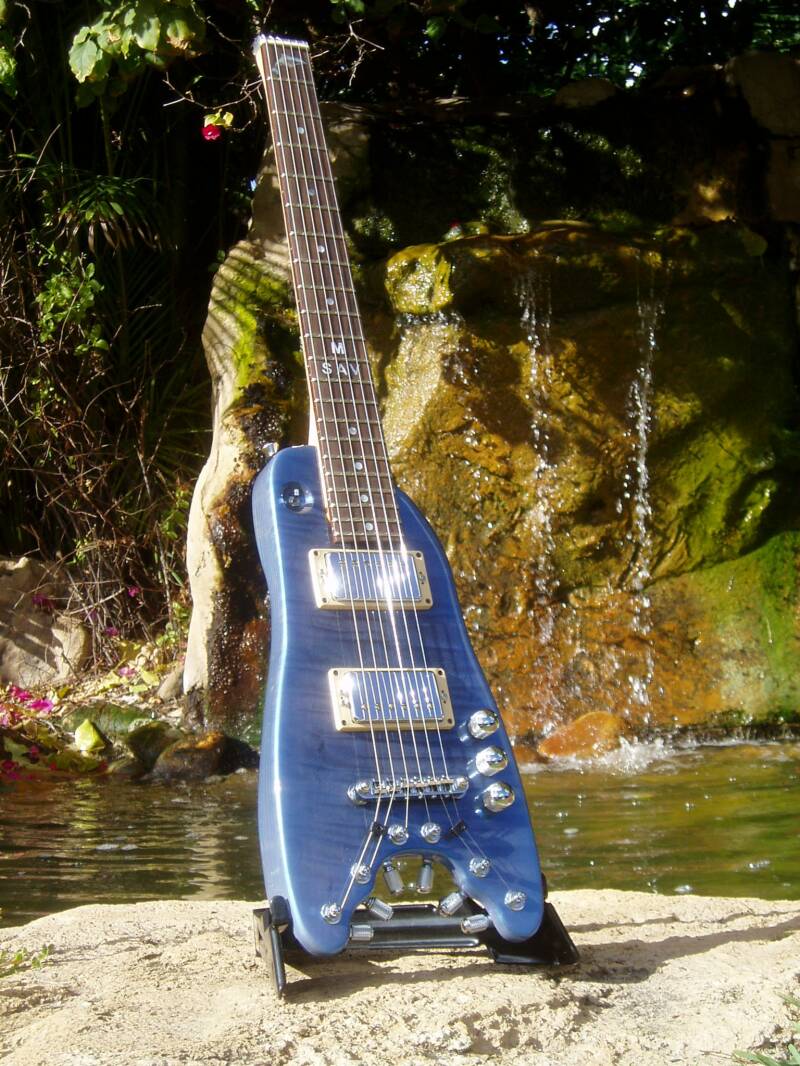 Pearly Blue Rambler Custom Travel Guitar by the waterfall