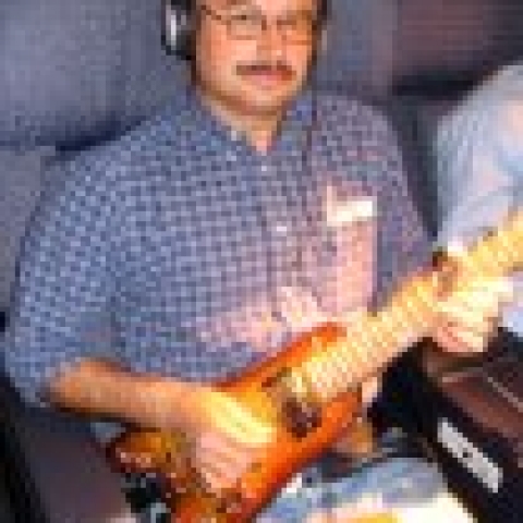 Jammin' in first class with a Rambler Travel Guitar