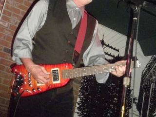 Roy Rogers playing his slice on his Rambler Travel Guitar