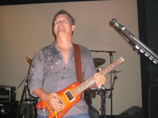 Scott with Split Image playing a Custom Rambler Portable Guitar