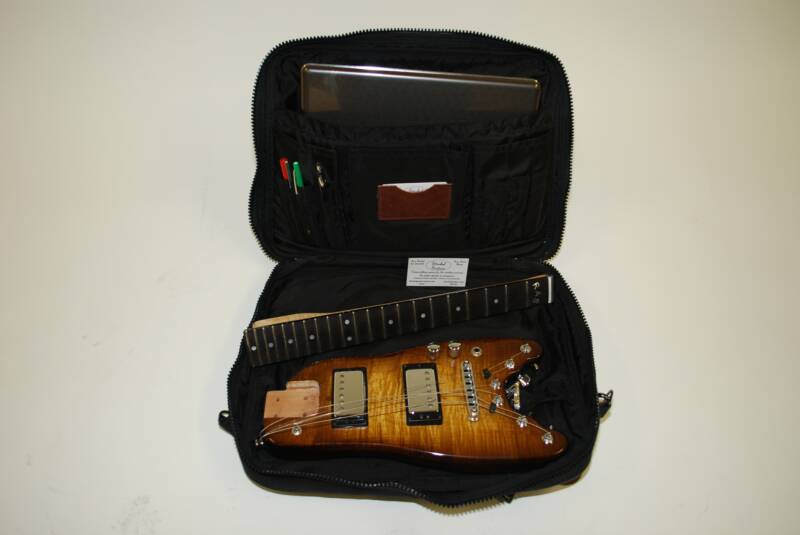 Rambler Electric Travel Guitar in a computer bag