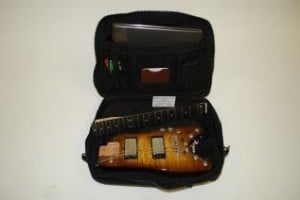 Rambler® travel guitar ready to go in a computer bag