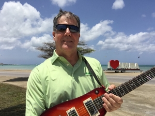 Brett with his Rambler Travel Guitar in Aruba
