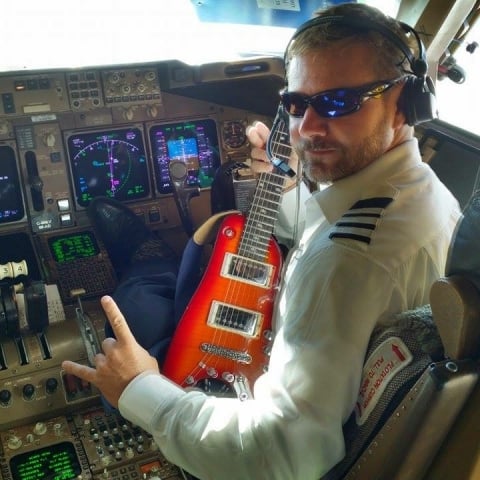 Capt. Buter in cockpit with his Rambler Travel Guitar