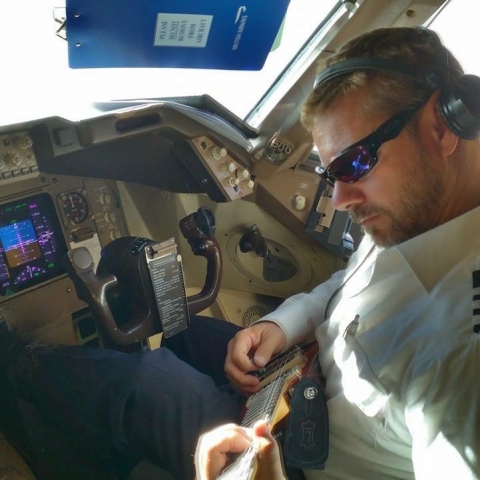 Capt. Buter jammin in the cockpit with his Rambler Portable Guitar