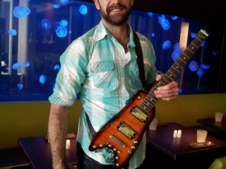Jay Harrison of Winnepeg Jets trying out his new Rambler Travel Guitar