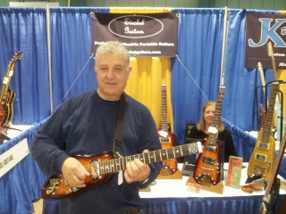 Rudy checking out a Rambler portable guitar at Long Island Guitar Show