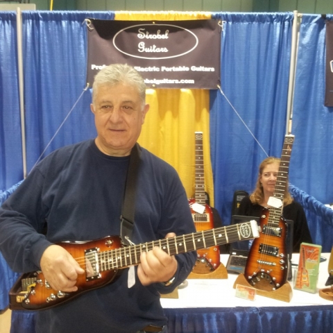 Rudy checking out a Rambler portable guitar at Long Island Guitar Show